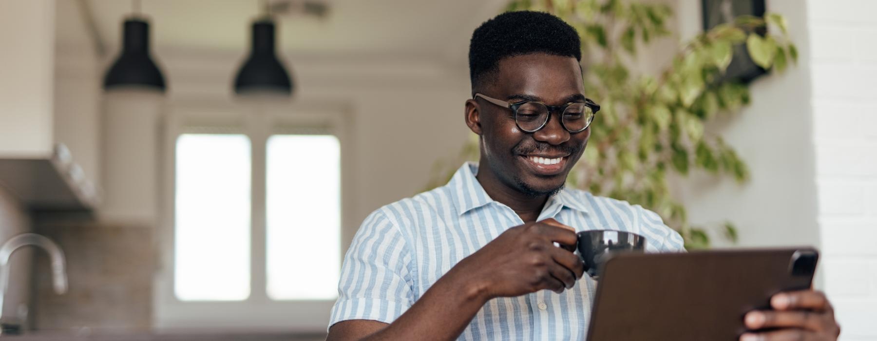 a man sitting at a table with a tablet